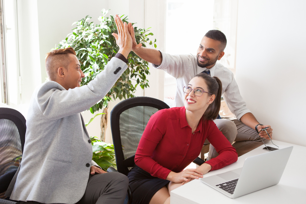 cheerful young startuppers giving high five 1
